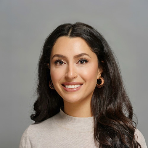 A woman with long hair smiling at the camera.