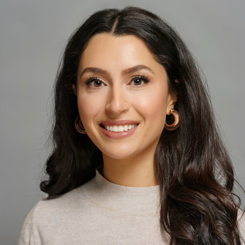 The image features a woman with long hair smiling at the camera.